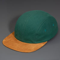 A Spruce Canvas Crown, Brown Flat Suede Bill, Blank 4 Panel Hat with Matching Canvas Strapback.  Designed by Blvnk Headwear.