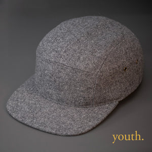 A Youth Sized, Warm, Heather Grey, Melton Wool, Blank 5 Panel Camp Hat With a Flat Bill, & Leather Strapback.