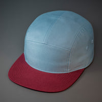 A Smoke Blue & Maroon, Cotton Twill, Blank 5 Panel Camp Hat With a Flat Bill, & Woven Nylon Strapback.  Designed by Blvnk Headwear.