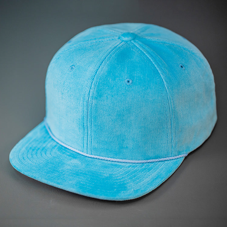 An Air Blue Corduroy, Blank 6 Panel Hat, with a Flat Bill & Classic Snapback  |  Designed by Blvnk Headwear