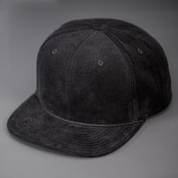 A Black Corduroy, Blank 6 Panel Hat, with a Flat Bill & Classic Snapback  |  Designed by Blvnk Headwear