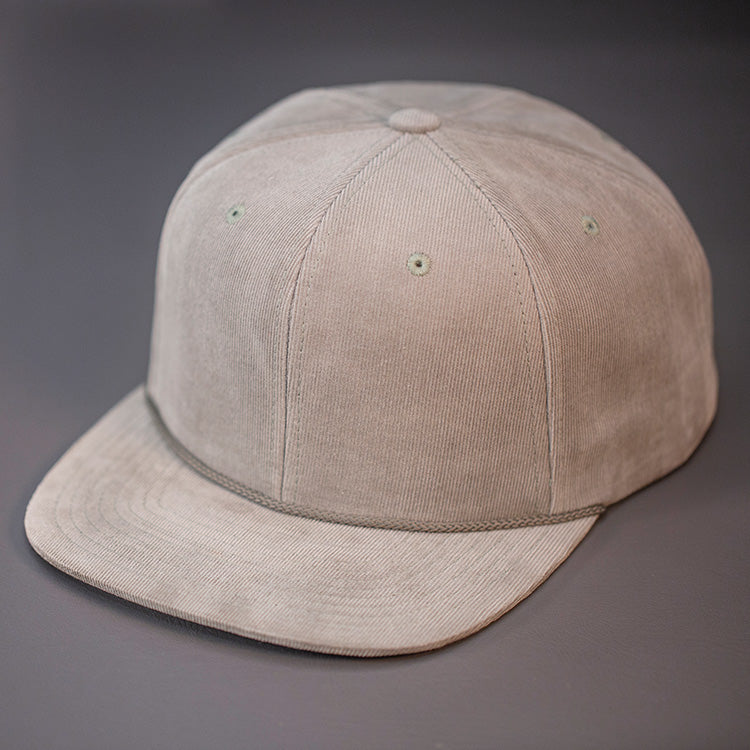A Tan Corduroy, Blank 6 Panel Hat, with a Flat Bill & Classic Snapback  |  Designed by Blvnk Headwear