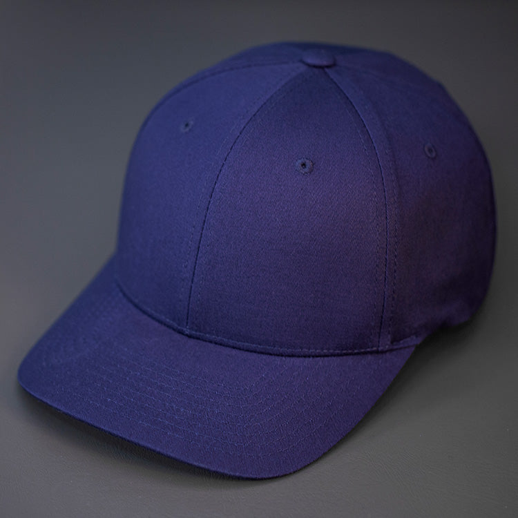 A Navy, 6 Panel, Blank, Flex Back Twill Crown Hat W/ a Pre Curved Bill.  Designed by Blvnk Headwear.