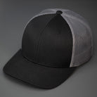 A Black and Charcoal, Cotton Twill, Mesh Backed, Blank Trucker Hat with a Pre Curved Bill, & Classic Snapback.  |  Designed by Blvnk Headwear
