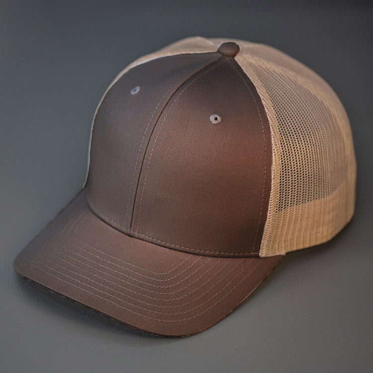 A Brown & Khaki, Cotton Twill, Mesh Backed, Blank Trucker Hat with a Pre Curved Bill, & Classic Snapback.  |  Designed by Blvnk Headwear