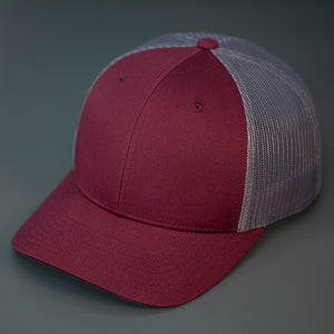 A Burgundy & Charcoal, Cotton Twill, Mesh Backed, Blank Trucker Hat with a Pre Curved Bill, & Classic Snapback.  |  Designed by Blvnk Headwear