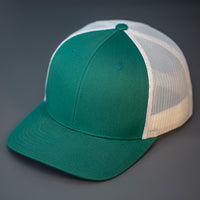 A Dark Green & Birch, Cotton Twill, Mesh Backed, Blank Trucker Hat with a Pre Curved Bill, & Classic Snapback.  |  Designed by Blvnk Headwear