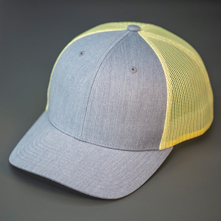 A Heather Grey & Chrome Yellow, Cotton Twill, Mesh Backed, Blank Trucker Hat with a Pre Curved Bill, & Classic Snapback.  |  Designed by Blvnk Headwear