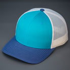 A Teal, Birch & Light Navy, Cotton Twill, Mesh Backed, Blank Trucker Hat with a Pre Curved Bill, & Classic Snapback.  |  Designed by Blvnk Headwear