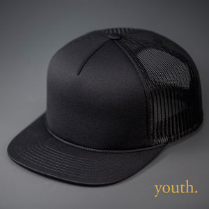 A Youth Sized, Black on Black, Foam Front, Mesh Backed Blank Trucker Hat with a Flat Bill, & Classic Snapback.  Designed by Blvnk Headwear.