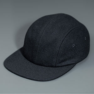 A Black, Melton Wool, Blank 4 Panel Hat with a Flat Bill, & Vegan Leather Strapback.  Designed by Blvnk Headwear.