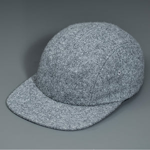 A Heather Grey, Melton Wool, Blank 4 Panel Hat with a Flat Bill, & Vegan Leather Strapback.  Designed by Blvnk Headwear.