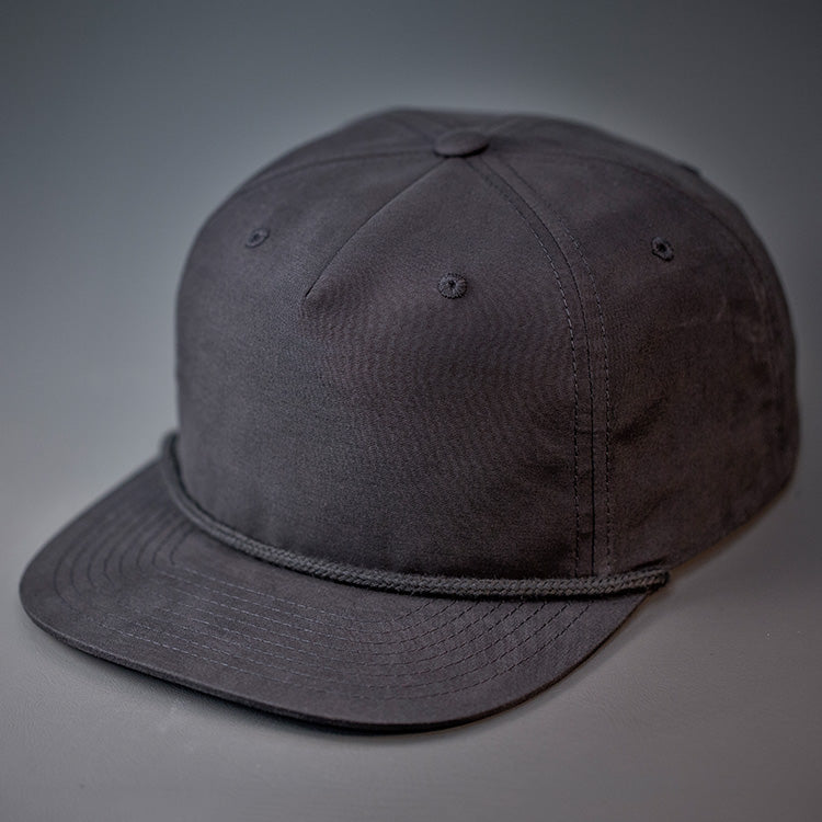 A Black, Grandpa Style Nylon, Pinch Front, Blank Flat Bill with a Black Rope & Classic Snapback.  Designed by Blvnk Headwear.