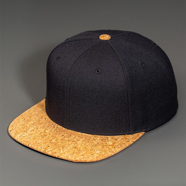 A Black Wool Crown, Blank 6 Panel Hat with a Cork Flat Bill & Classic Snapback.  Designed by Blvnk Headwear.