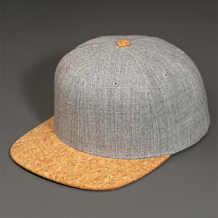 A Heather Grey Wool Crown, Blank 6 Panel Hat with a Cork Flat Bill & Classic Snapback.  Designed by Blvnk Headwear.