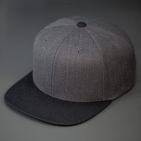 A Heather Charcoal & Black, Wool, 6 Panel, Flat Bill, Blank Snapback.  Designed by Blvnk Headwear.