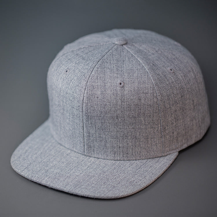 A Heather Grey, Blank Flex Fit, flat bill hat available in S/M & L/XL.  Designed by Blvnk Headwear.