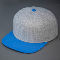 A Heather Grey & Lions Blue, Wool, 6 Panel, Flat Bill, Blank Snapback.  Designed by Blvnk Headwear.