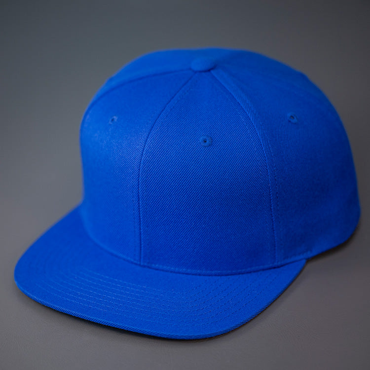 A Royal, Wool, 6 Panel, Flat Bill, Blank Snapback.  Designed by Blvnk Headwear.