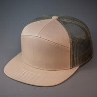 A Pale Khaki & Loden, Cotton Twill, Mesh Backed Blank 7 Panel Trucker Hat with a Flat Bill, & Classic Snapback.  Designed by Blvnk Headwear