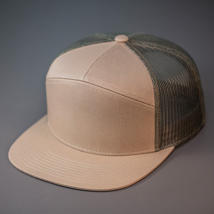 A Pale Khaki & Loden, Cotton Twill, Mesh Backed Blank 7 Panel Trucker Hat with a Flat Bill, & Classic Snapback.  Designed by Blvnk Headwear