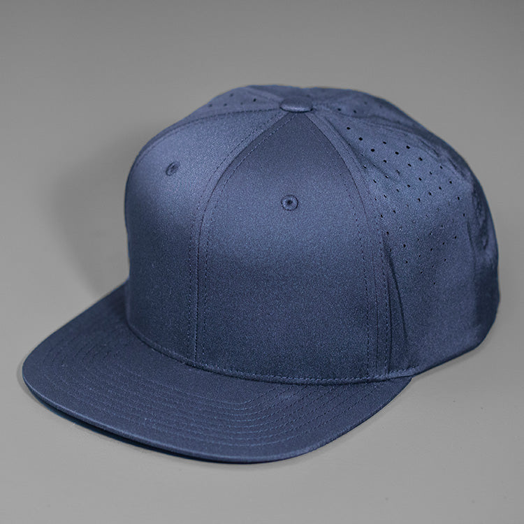 A Navy Performance Stretch Crown, Blank 6 Panel Hat, Featuring Custom Perforated Back Panels, Flat Bill & Classic Snapback.  Designed by Blvnk Headwear.