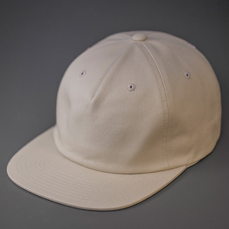 A Birch, Unstructured, Premium Cotton, Blank Pinch Front Hat With a Vegan Leather Back Strap & Brass Clasp.  Designed By Blvnk Headwear.
