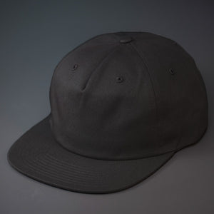 A Black, Unstructured, Premium Cotton, Blank Pinch Front Hat With a Vegan Leather Back Strap & Brass Clasp.  Designed By Blvnk Headwear.