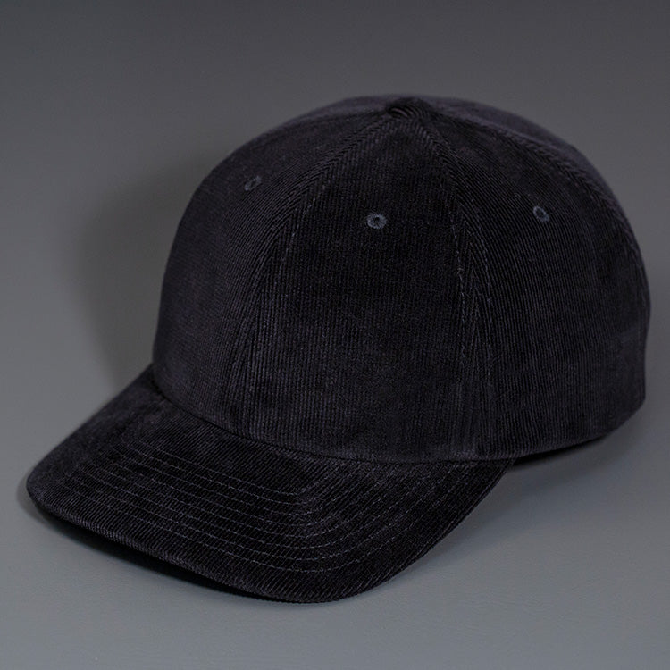 A Black Corduroy, 6 Panel Crown, Blank Dad Hat with a matching fabric Back Strap & Brass Clasp.  Designed by Blvnk Headwear.