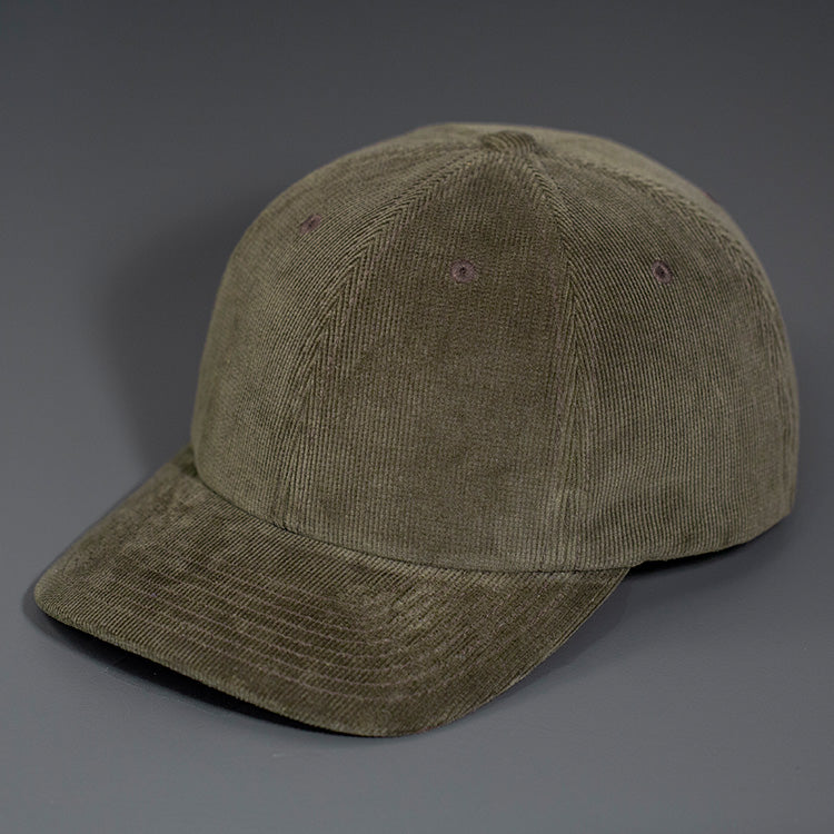 A Dark Loden Corduroy, 6 Panel Crown, Blank Dad Hat with a matching fabric Back Strap & Brass Clasp.  Designed by Blvnk Headwear.