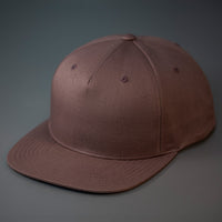 A Brown Colored, Cotton Twill, Pinch Front, Blank Snapback Hat.  Designed & Manufactured by Blvnk Headwear.