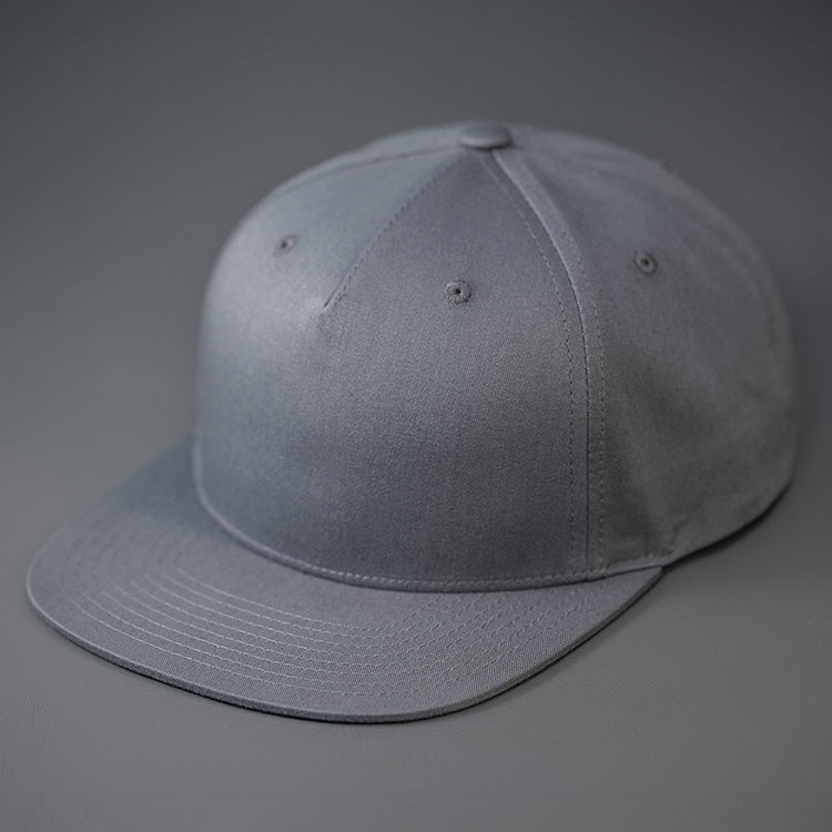 A Flint Grey Colored, Cotton Twill, Pinch Front, Blank Snapback Hat.  Designed & Manufactured by Blvnk Headwear.