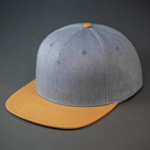 A Heather Grey & Biscuit Colored, Cotton Twill, Pinch Front, Blank Snapback Hat.  Designed & Manufactured by Blvnk Headwear.