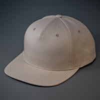 A Khaki Colored, Cotton Twill, Pinch Front, Blank Snapback Hat.  Designed & Manufactured by Blvnk Headwear.