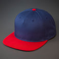 A Navy & Red Colored, Cotton Twill, Pinch Front, Blank Snapback Hat.  Designed & Manufactured by Blvnk Headwear.