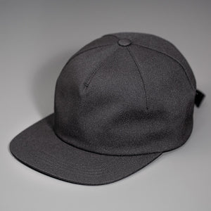 A Black Chambray, Blank 1 Panel Hat, W/ a Flat Bill & Woven Nylon Strapback.  Designed by Blvnk Headwear.