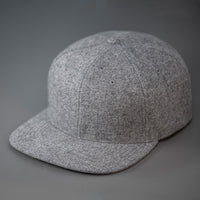 A Heather Grey, Melton Wool, Blank 6 Panel Hat With a Flat Bill.  Designed by Blvnk Headwear.