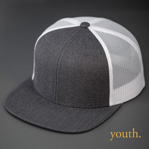 A Youth Sized, Heather Charcoal Wool Crown, Blank Trucker Hat, With White Mesh Back Panels, Flat Bill & Classic Snapback.  Designed by Blvnk Headwear.