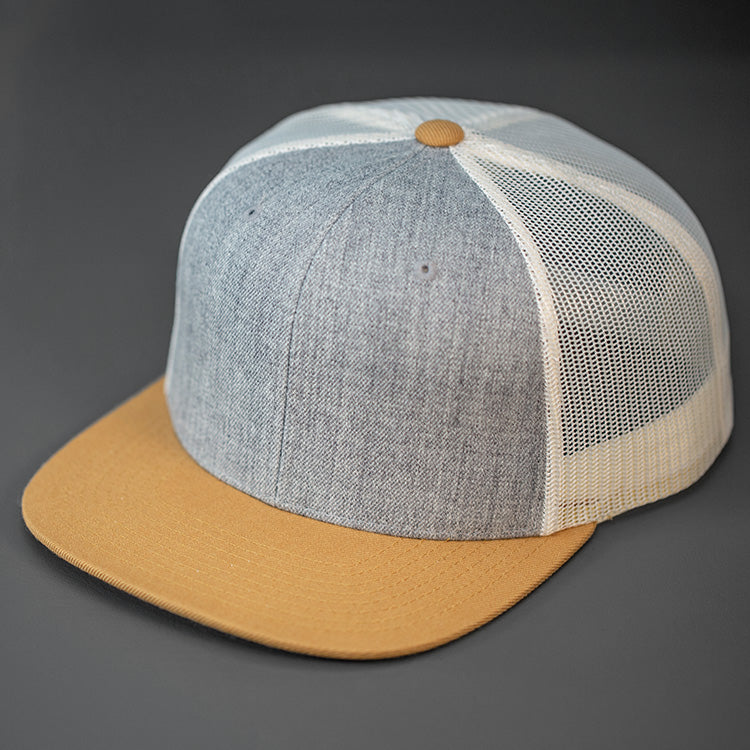 A Heather Grey Wool Crown, Blank Trucker Hat, With Birch Mesh Back Panels, Biscuit Colored Flat Bill & Classic Snapback.  Designed by Blvnk Headwear.