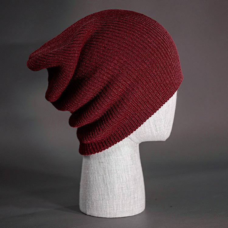 A Burgundy colored, super slouch knit blank beanie. Designed by Blvnk Headwear.
