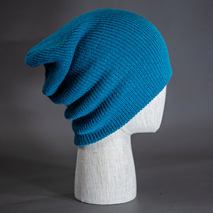 A Deep Blue colored, super slouch knit blank beanie. Designed by Blvnk Headwear.