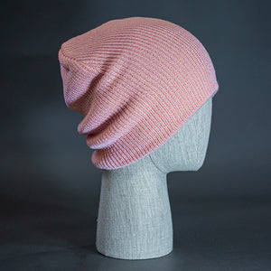 The Burnside Beanie, a coral pink colored, soft slouch knit, blank beanie. Designed by Blvnk Headwear.