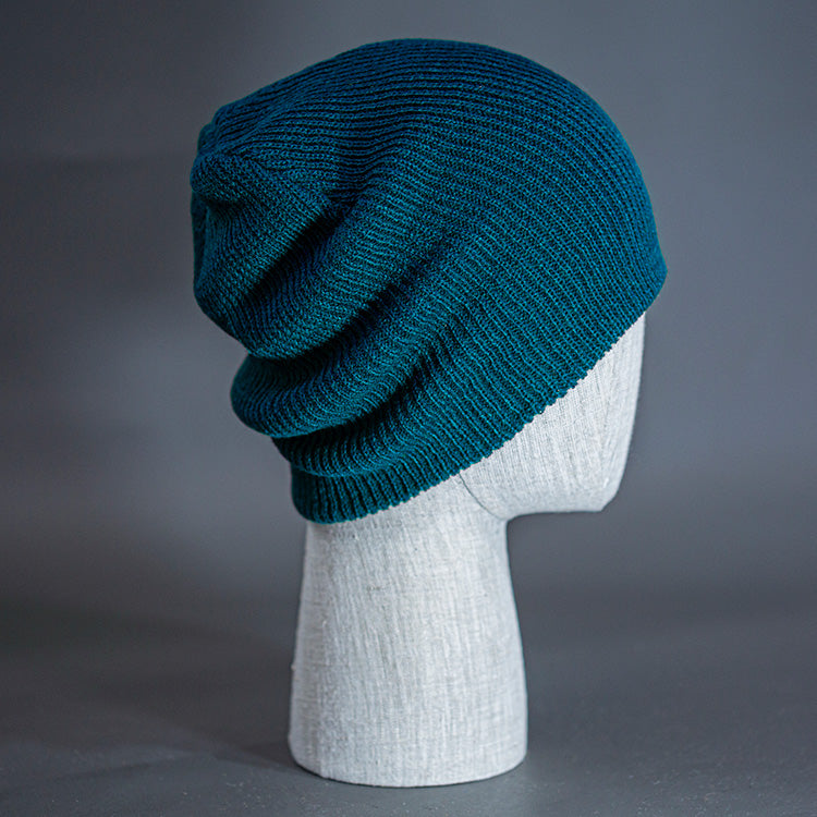 The Burnside Beanie, a deep blue colored, soft slouch knit, blank beanie. Designed by Blvnk Headwear.