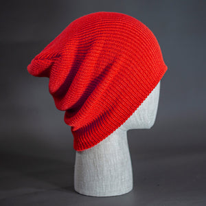 A red colored, super slouch knit blank beanie.  Designed by Blvnk Headwear.