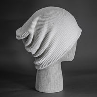 A white colored, super slouch knit blank beanie.  Designed by Blvnk Headwear.