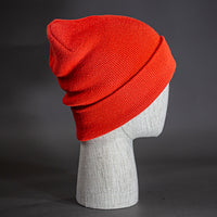 The Hood Beanie, a blaze orange colored, tight knit, mid length blank beanie. Designed by Blvnk Headwear.