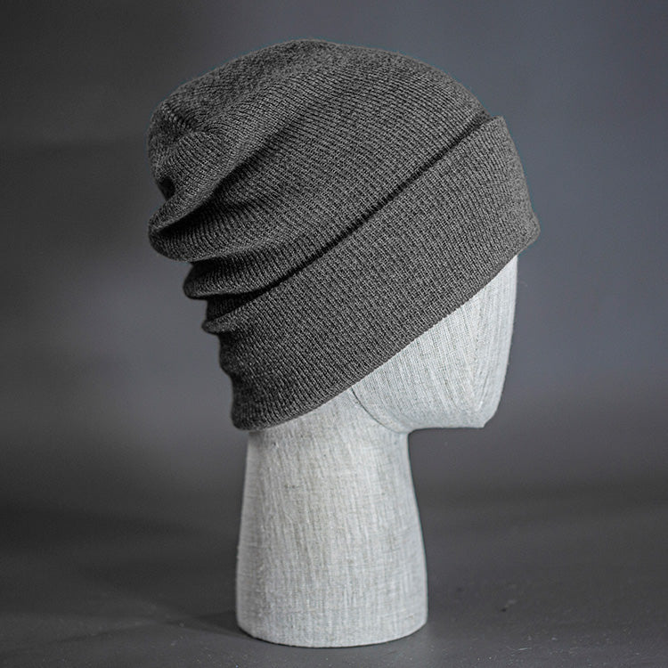 The Hood Heathered Beanie, a heather charcoal colored, tight knit, mid length blank beanie. Designed by Blvnk Headwear.