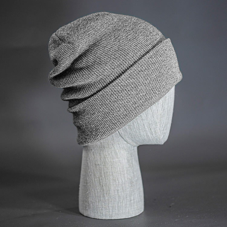The Hood Heathered Beanie, a heather grey colored, tight knit, mid length blank beanie. Designed by Blvnk Headwear.