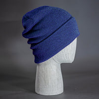 The Hood Heathered Beanie, a heather navy colored, tight knit, mid length blank beanie. Designed by Blvnk Headwear.