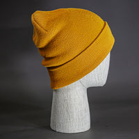 The Hood Beanie, a wheat colored, tight knit, mid length blank beanie. Designed by Blvnk Headwear.